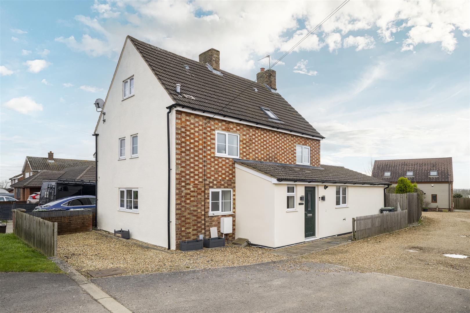 Traditional British detached house with brick exterior.